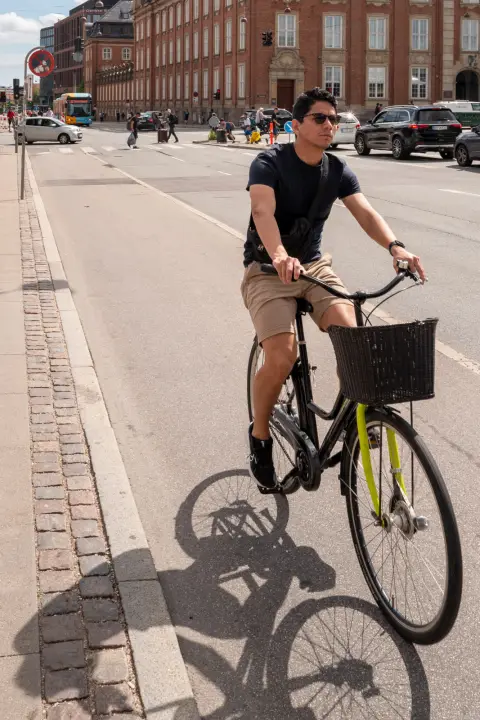 A cyclist and his shadow on the bike lane, Copenhagen