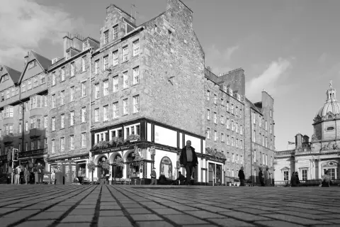Cobbled square, tall stone facades and a dome, Edinburgh