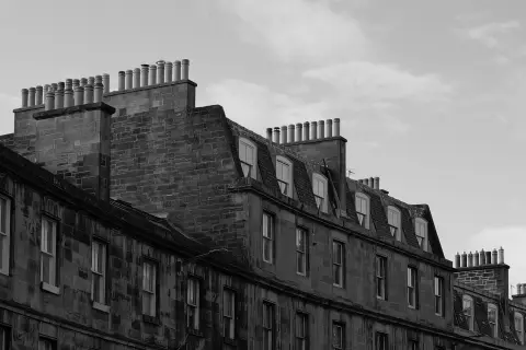 Rooftops bristling with chimney pots above a row of facades, Edinburgh