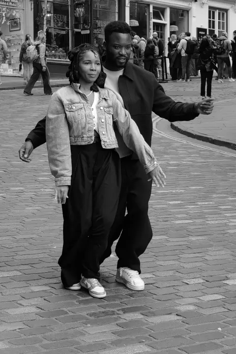 Couple dancing in the middle of a cobbled street, Edinburgh