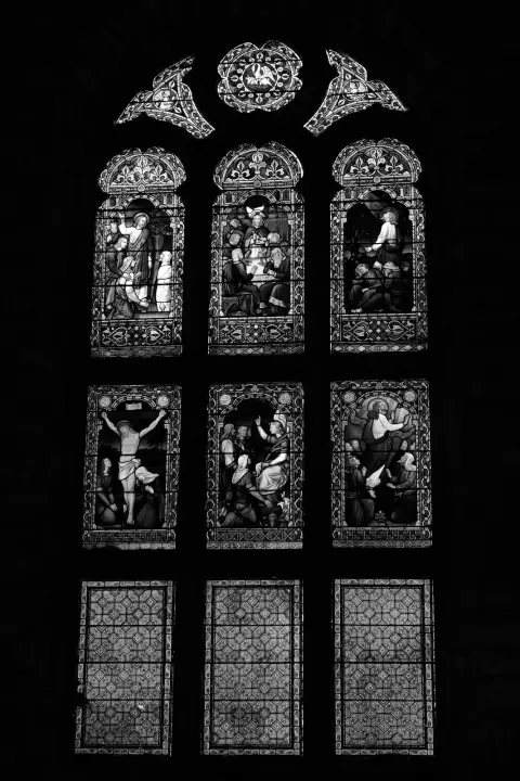 Stained-glass window glowing in the dark of a church, Edinburgh