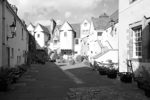 Cobbled courtyard lined with white gabled houses, Edinburgh