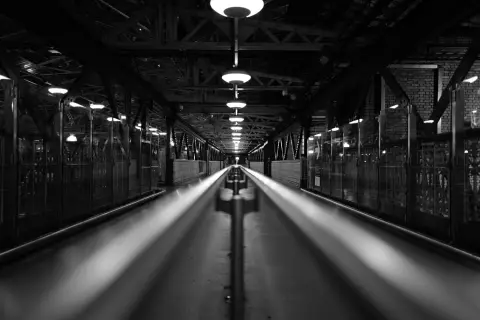 Long covered walkway lit by pendant lamps at night, Edinburgh