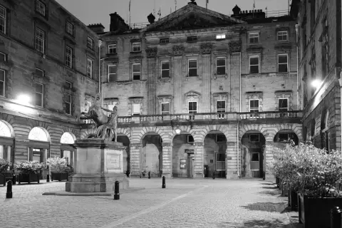 Floodlit courtyard and equestrian statue at night, Edinburgh