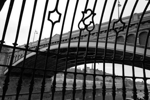 Iron bridge seen through a wrought-iron railing, Edinburgh