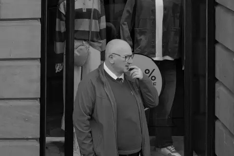 Thoughtful man in front of a clothing shop window, Edinburgh