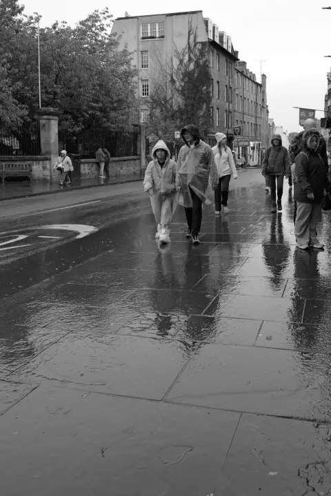 People in rain jackets on a soaked pavement, Edinburgh