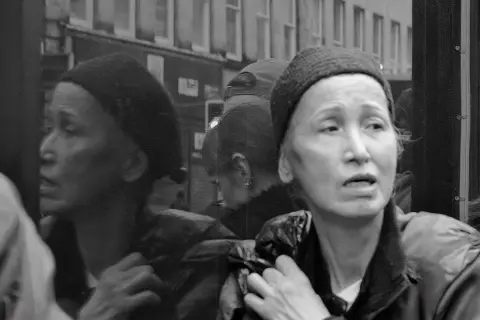 Two women with anxious looks in the crowd, Edinburgh