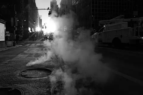 Vapeur rétroéclairée par le soleil levant entre les immeubles, New York