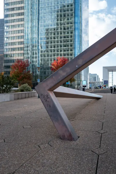 A zigzag steel sculpture on the esplanade, at the foot of the towers, Paris