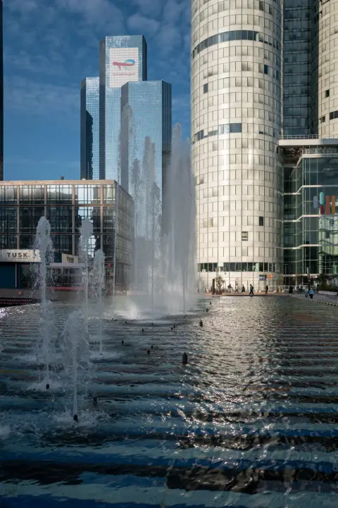 The jets of a fountain in front of the glass towers, Paris