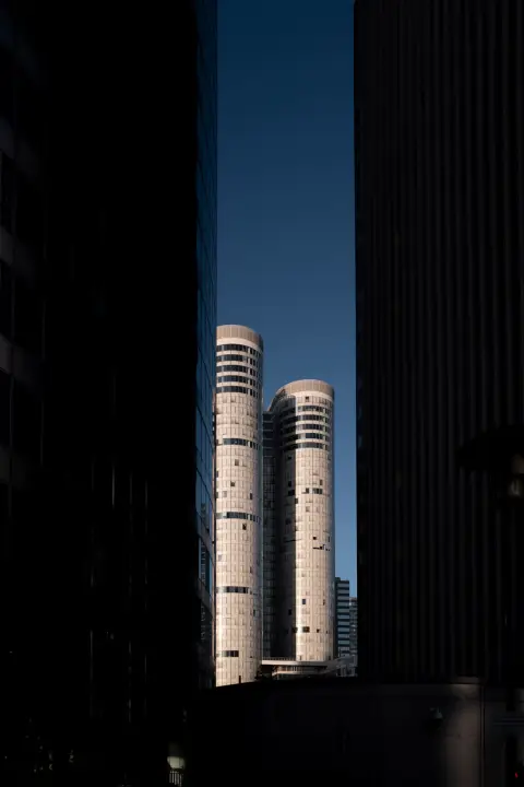 Two twin round towers between two black walls, Paris