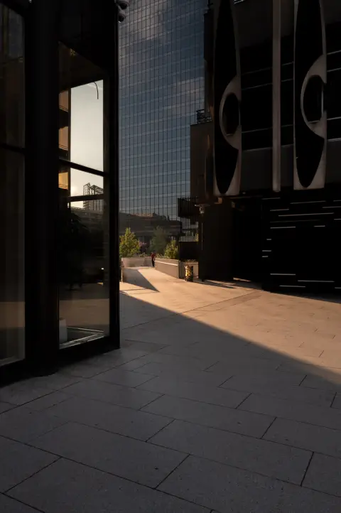The low evening light on the paving, between glass doors, Paris