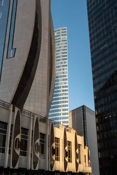 Curved facades and glass towers in the setting sun, Paris
