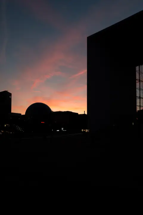 The silhouette of a dome under a pink sky, Paris