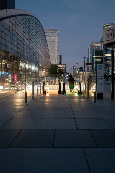 The RER entrance lit up at dusk, Paris