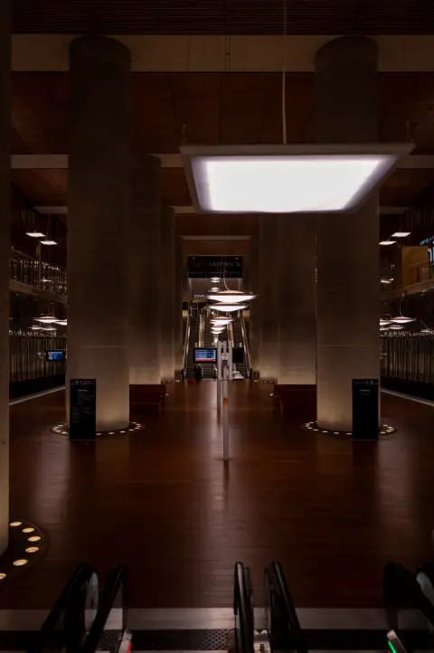 An underground hall with concrete pillars and a wooden floor, Paris