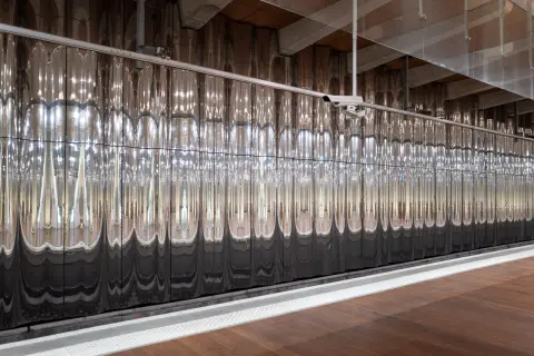 A wall of shimmering reflections along a platform, Paris