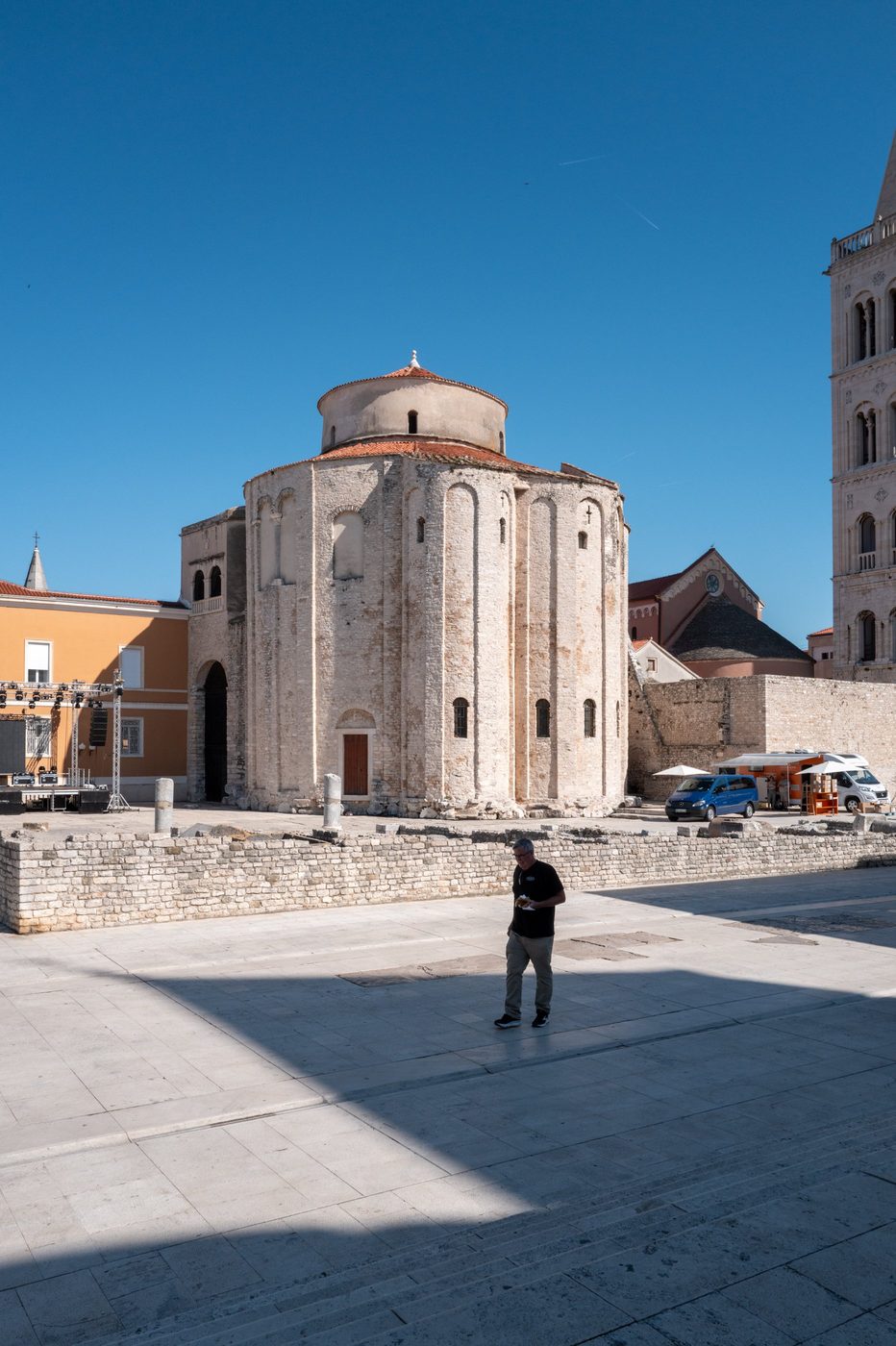 A passerby in front of the round Romanesque church of St. Donatus, Zadar