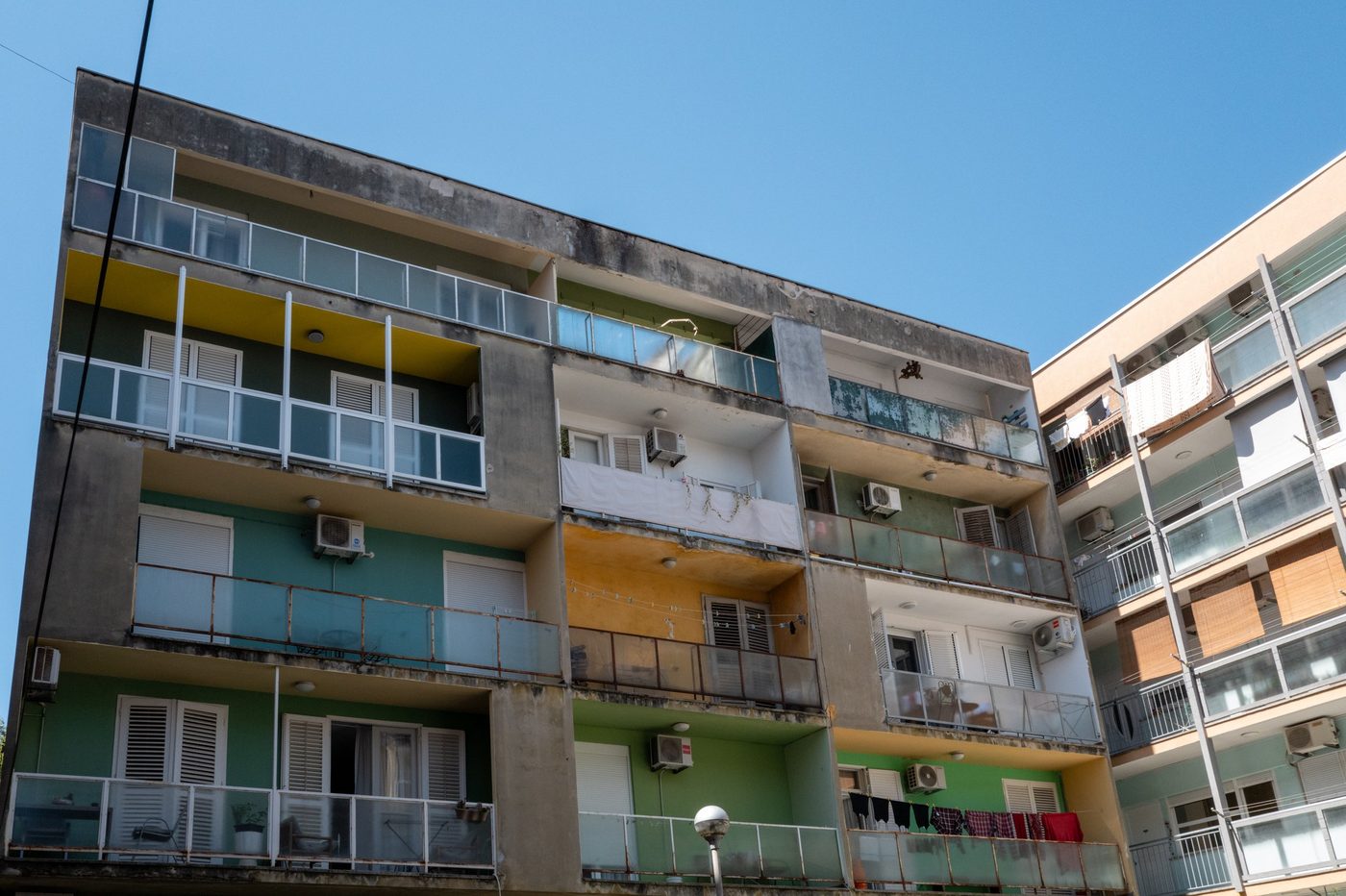 Apartment building with colorful balconies seen from below, Zadar