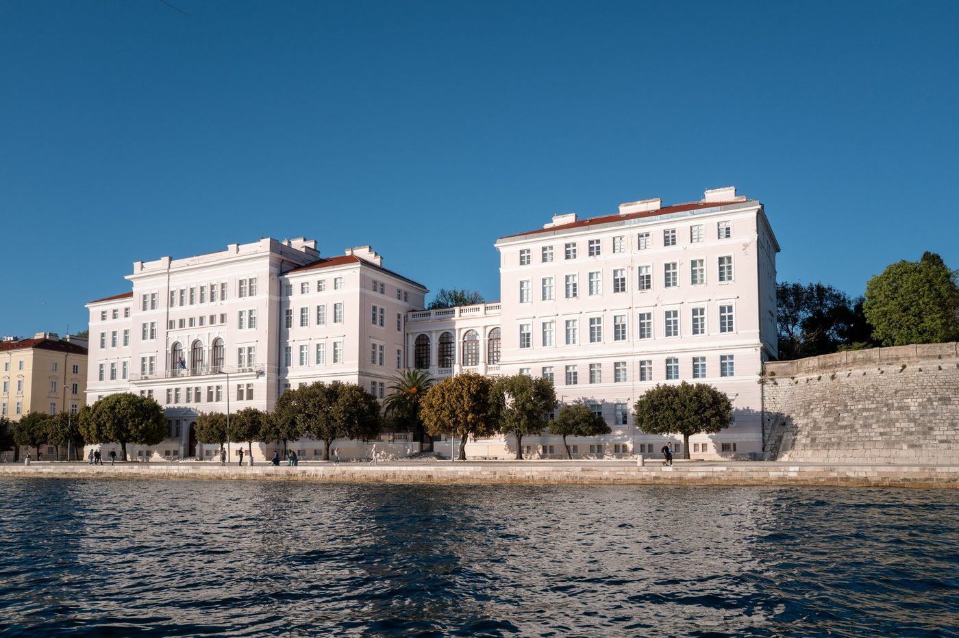 Long pink neoclassical building along the waterfront, Zadar