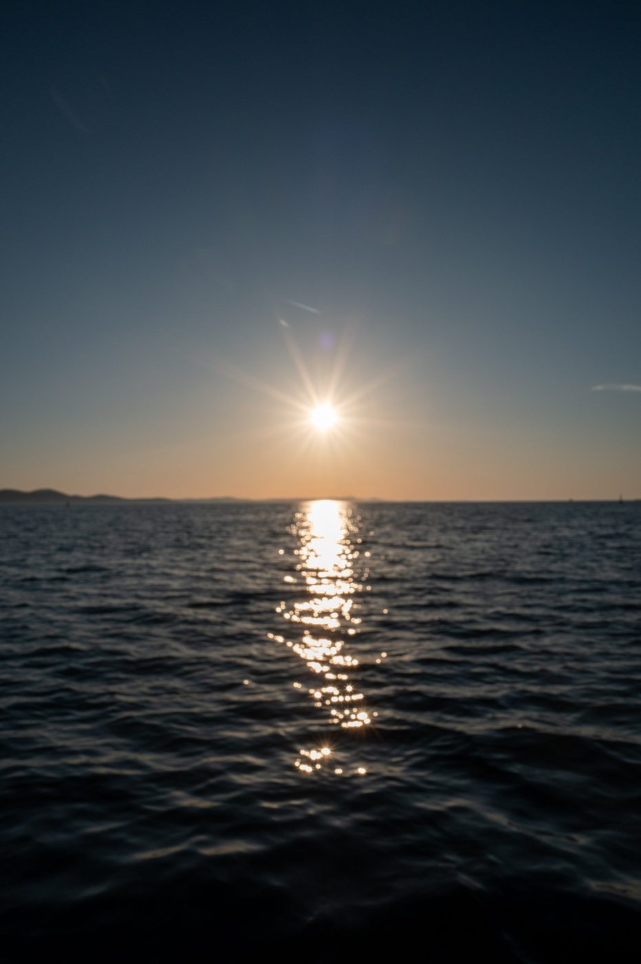 Orange sunset reflected on a dark sea, Zadar