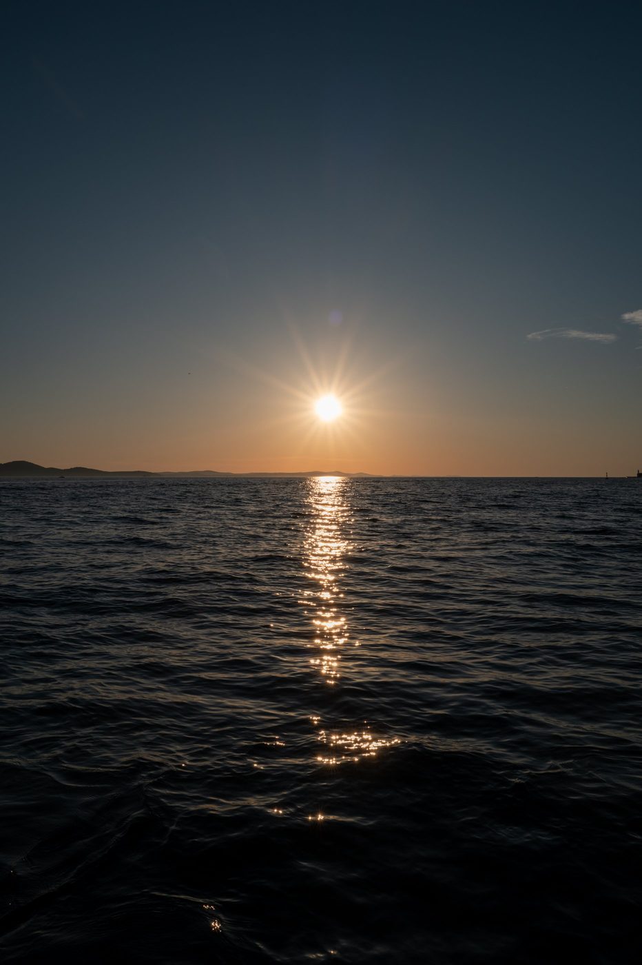 Last glow of the setting sun on the sea horizon, Zadar