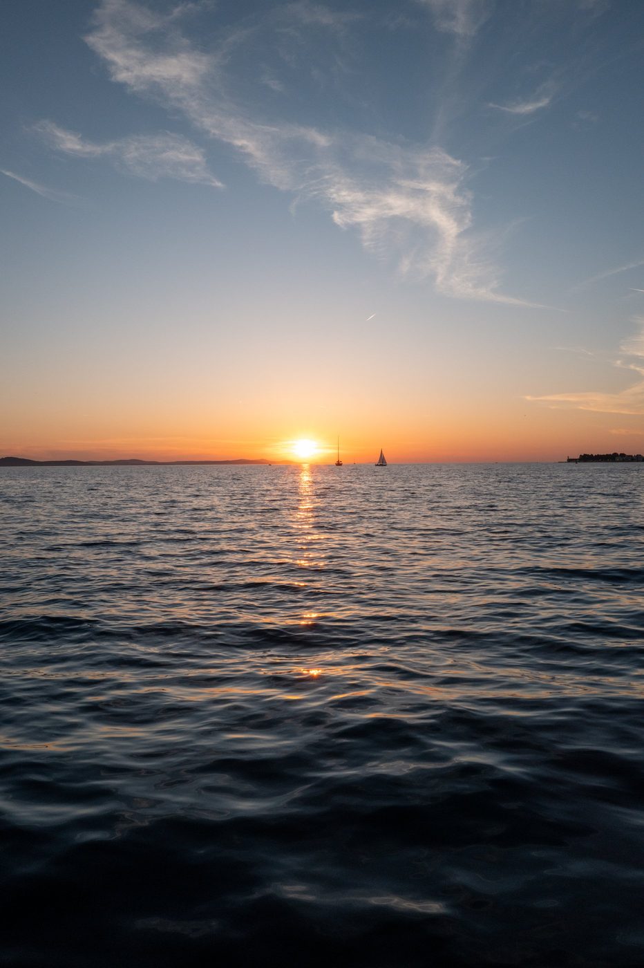 Two sailboats silhouetted at sunset over the Adriatic, Zadar