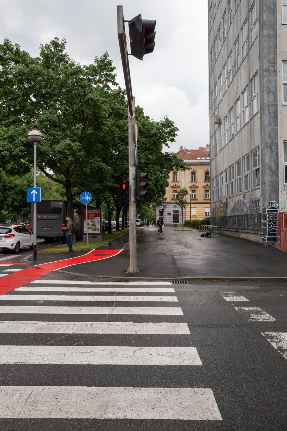 Red pedestrian signal above a crosswalk painted red, Zagreb