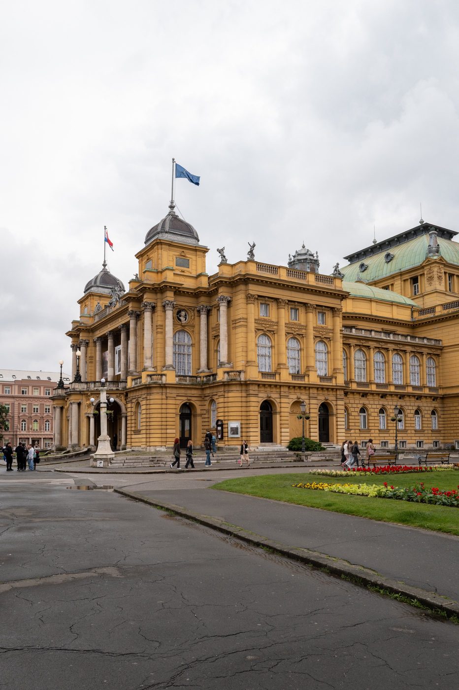 Yellow neo-baroque façade of the national theater and its silver dome, Zagreb