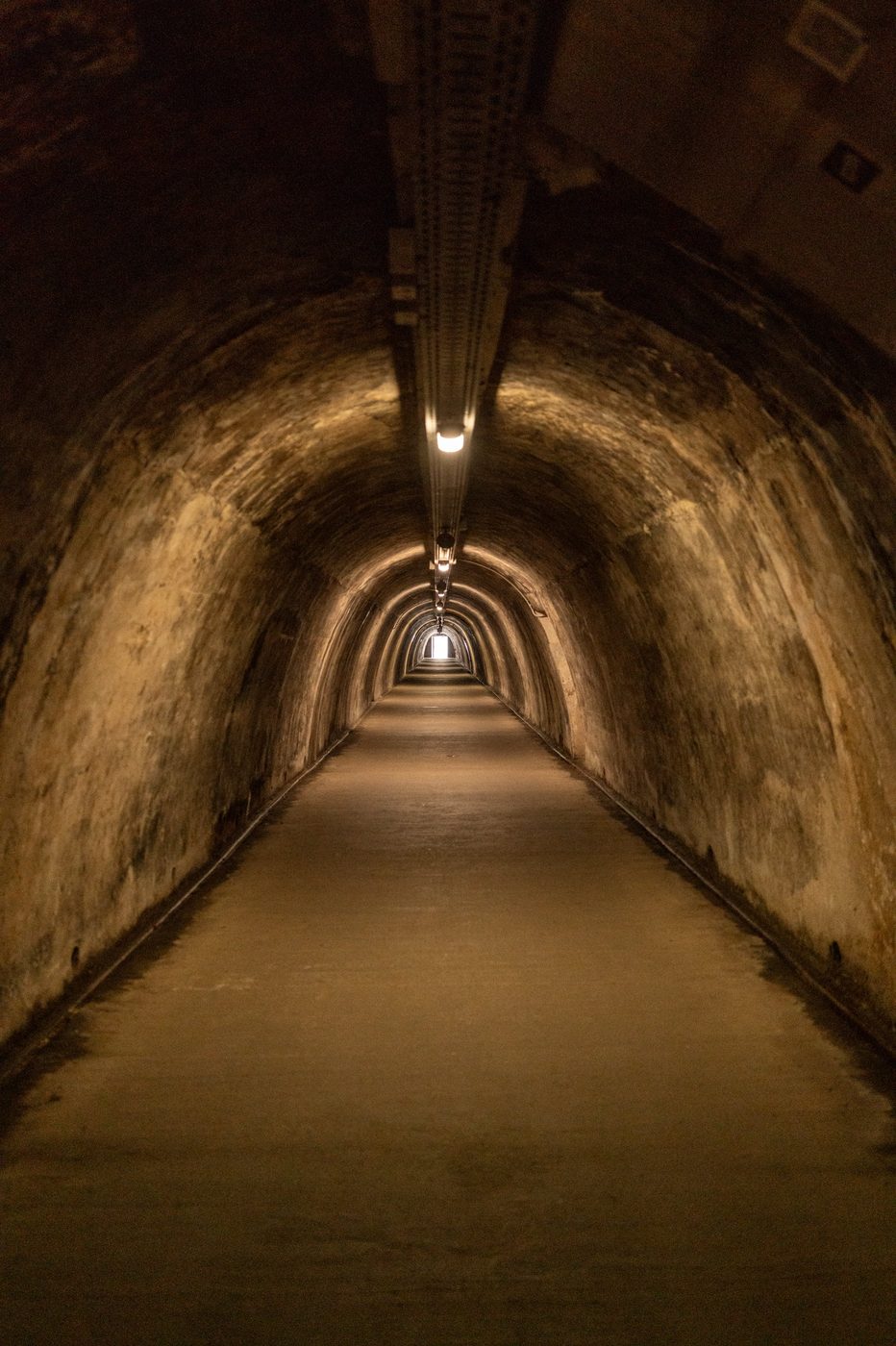 Long vaulted Grič tunnel lit by scattered lamps, Zagreb