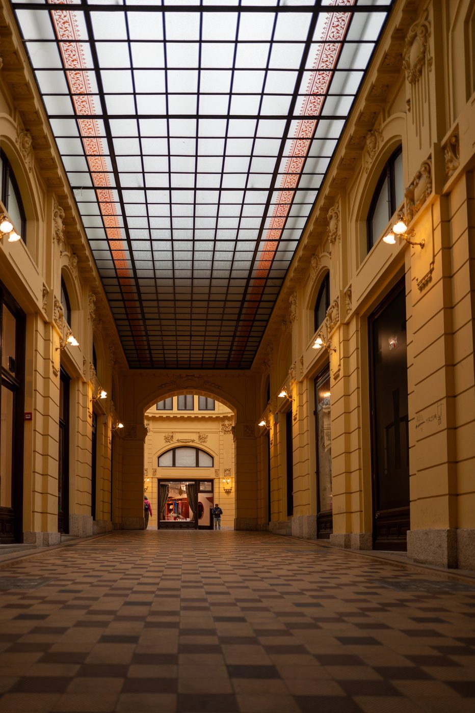 Vaulted glass shopping arcade, two passersby in the distance, Zagreb