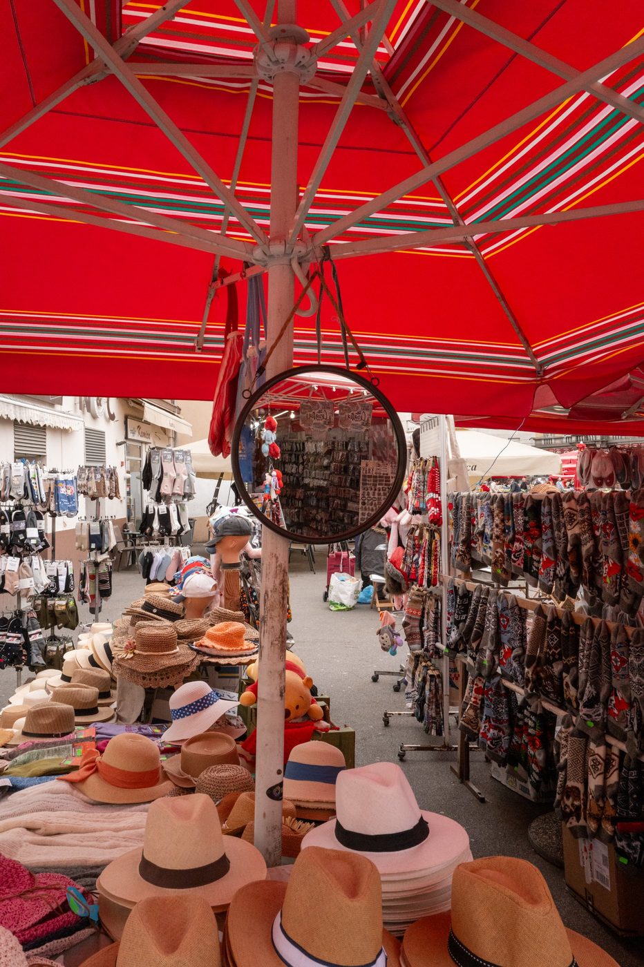 Stall of straw hats beneath a red-striped parasol, Zagreb