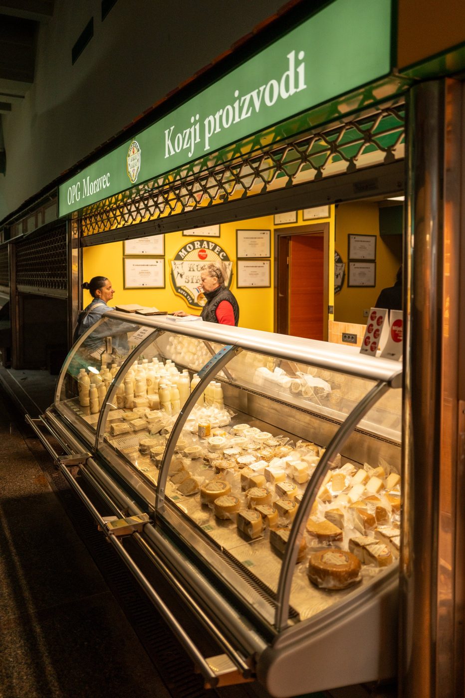 Goat cheese vendor chatting with a customer, Zagreb