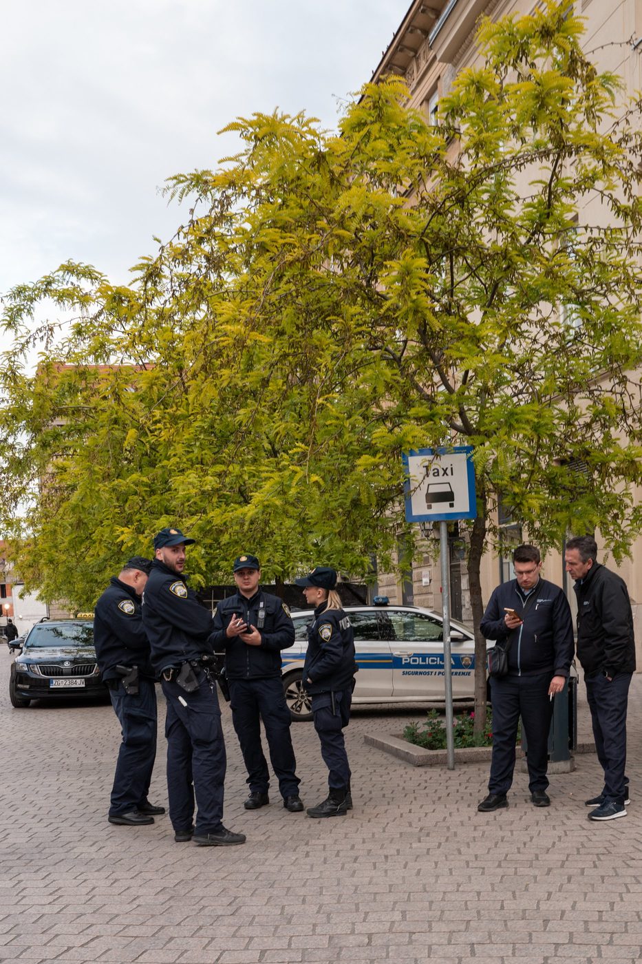 Group of police officers talking near a patrol car, Zagreb